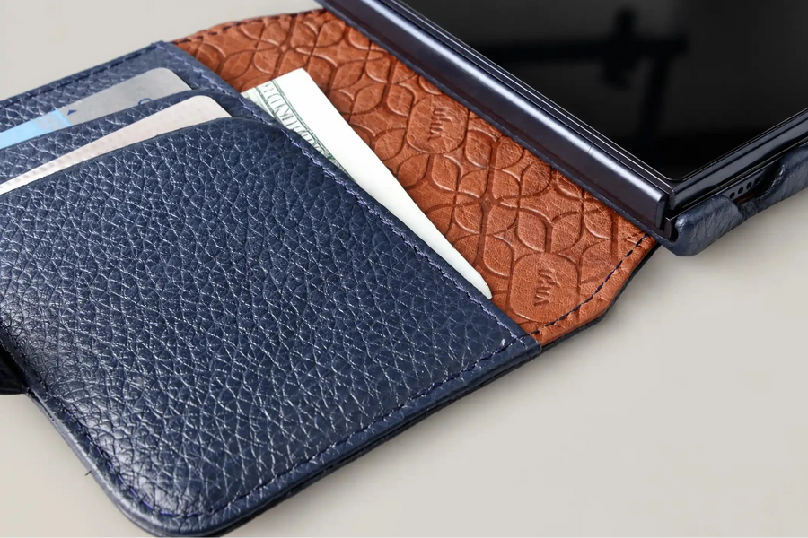 A Vaja Duo Wallet in Floater Indigo, open, cards and a note in the leather-lined pockets